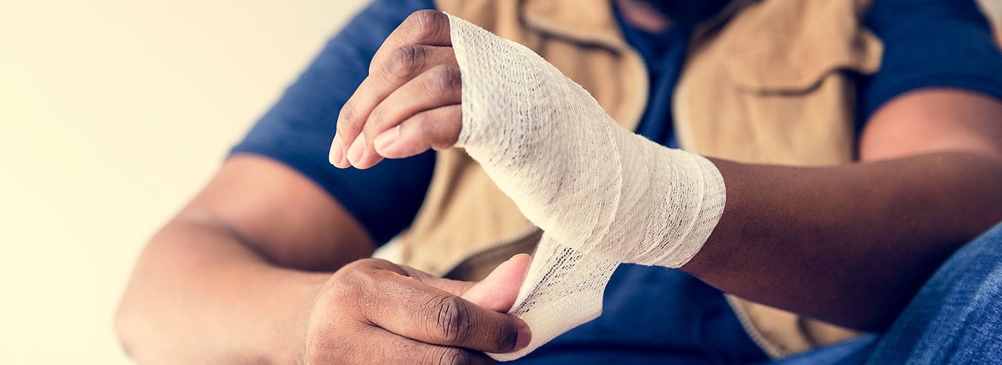 injured worker wrapping his wrist in a bandage