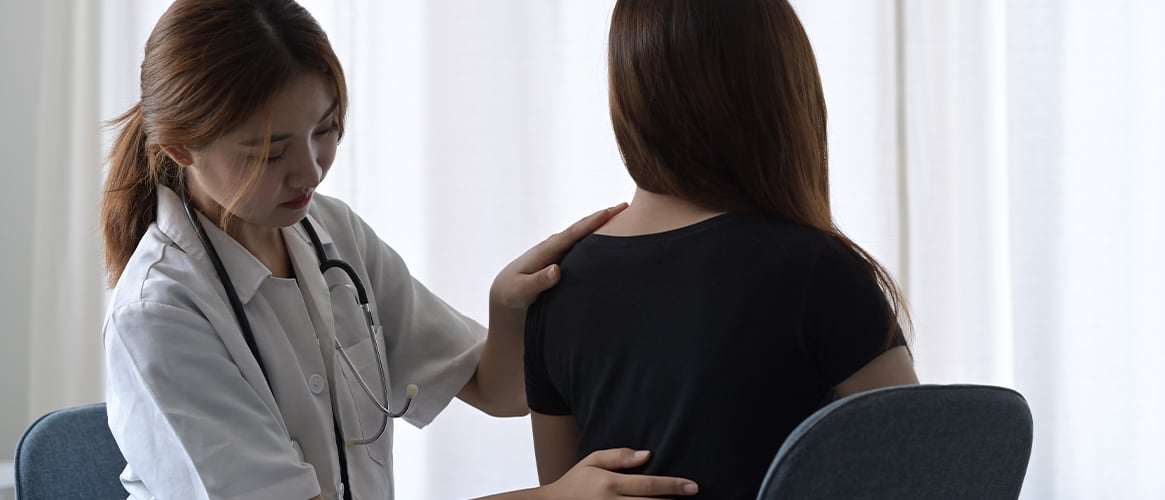 Female physiotherapist examines a patient.